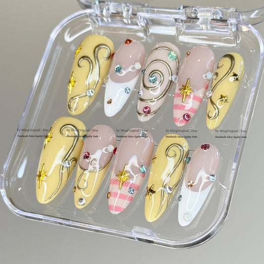Pastel Celestial Press-On Nails – Handmade Yellow & Pink Swirl Nails with Crystal Charms and Star Accents